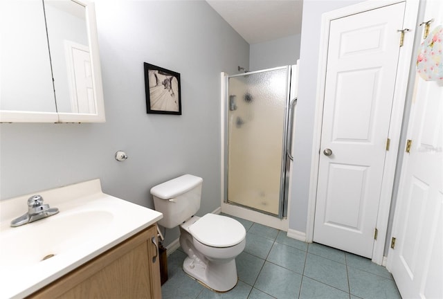 bathroom with vanity, tile patterned floors, a shower with shower door, and toilet