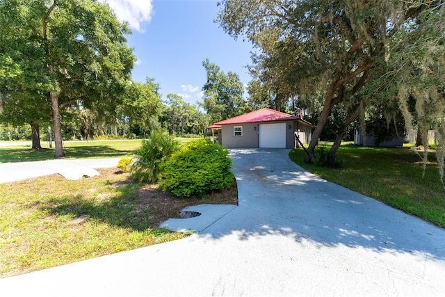 view of front of home featuring a garage and a front lawn