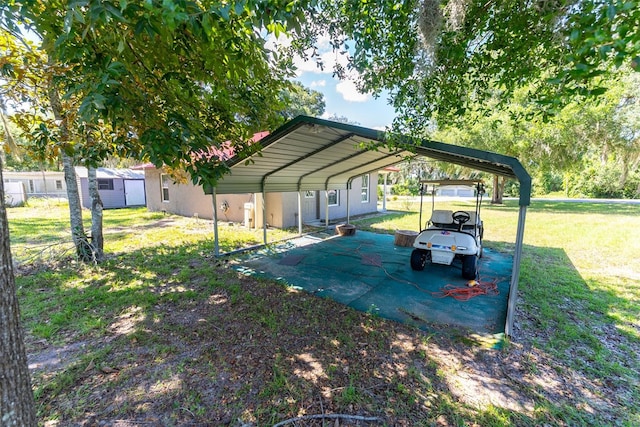 view of vehicle parking with a yard and a carport