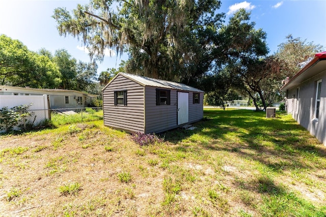 view of yard with cooling unit and a storage shed