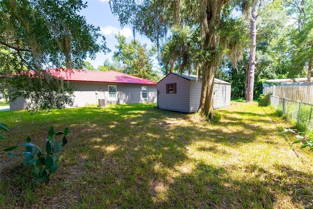 view of yard with a shed and central air condition unit