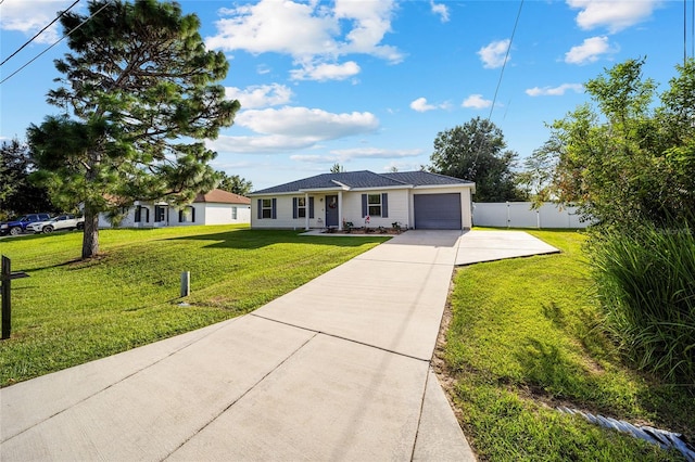 ranch-style house featuring a front yard and a garage