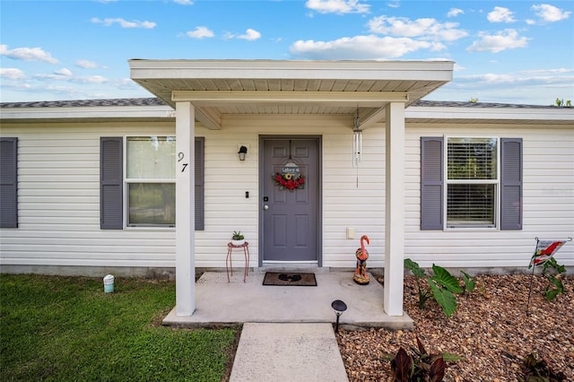 doorway to property featuring a yard