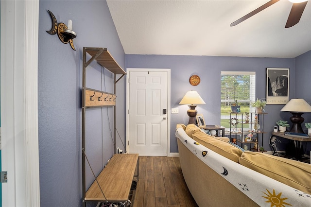 living room featuring ceiling fan and dark hardwood / wood-style floors