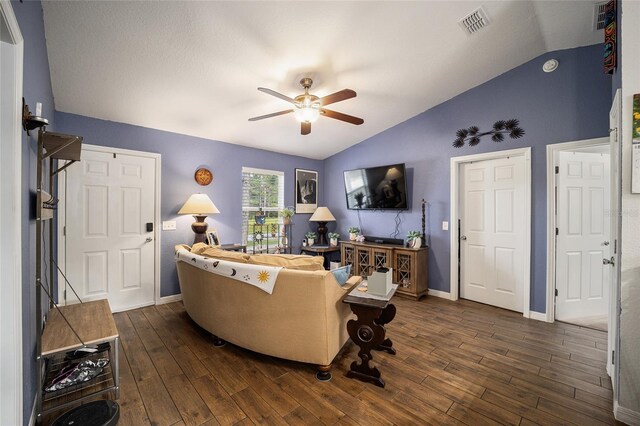 living room featuring lofted ceiling, ceiling fan, and dark hardwood / wood-style floors