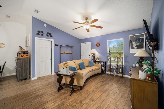 living room with wood-type flooring, lofted ceiling, and ceiling fan