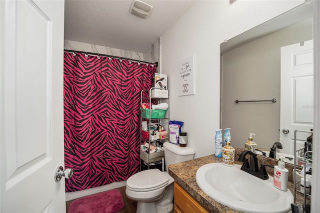 bathroom with a shower with curtain, vanity, toilet, and a textured ceiling