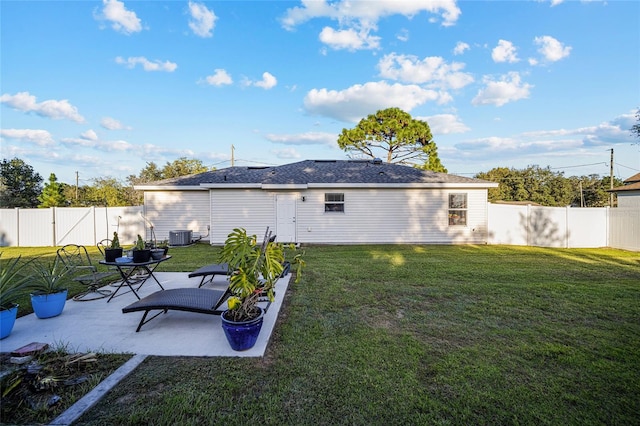 back of house with a lawn and a patio area