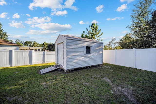 view of outbuilding with a yard