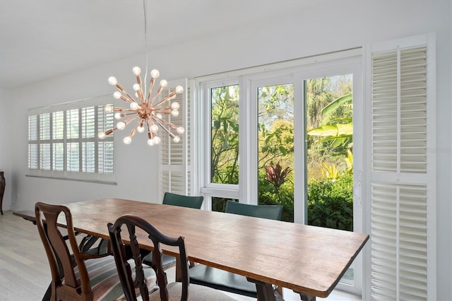 dining space with a chandelier and wood finished floors