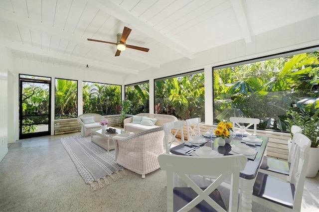 unfurnished sunroom featuring ceiling fan and beam ceiling