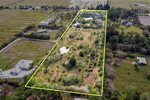 birds eye view of property with a rural view