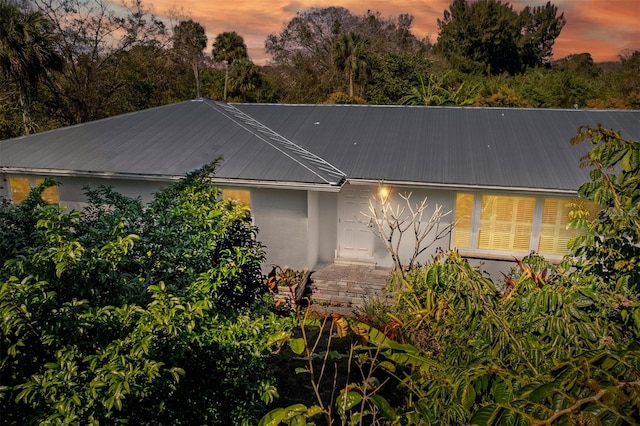 view of front of home with metal roof and stucco siding