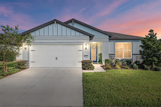 view of front of home with a yard and a garage