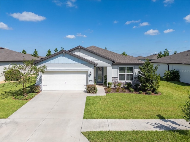 view of front of property featuring a front yard and a garage