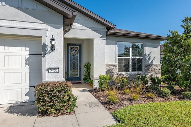 doorway to property with a garage