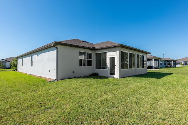 back of house with a lawn