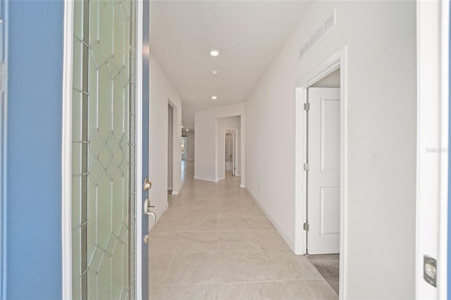 corridor with light tile patterned flooring