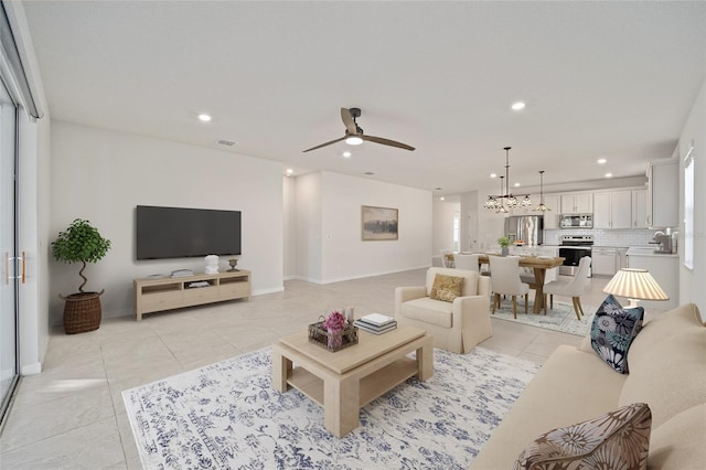 living room featuring ceiling fan and light tile patterned floors