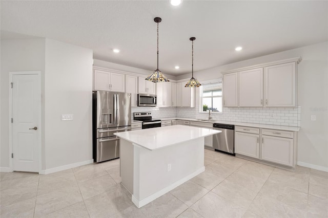 kitchen with white cabinetry, a center island, stainless steel appliances, tasteful backsplash, and decorative light fixtures