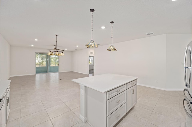 kitchen featuring a center island, light tile patterned flooring, and hanging light fixtures