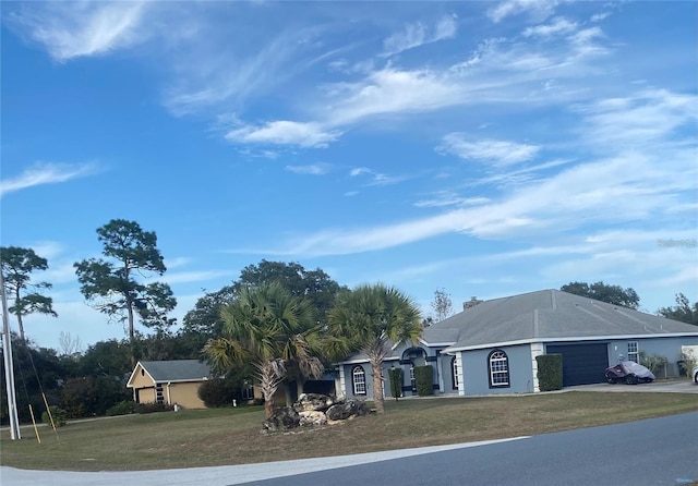 exterior space with a front yard and a garage