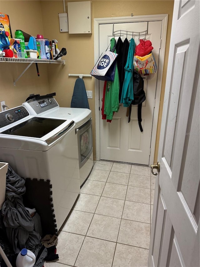 washroom with separate washer and dryer and light tile patterned floors