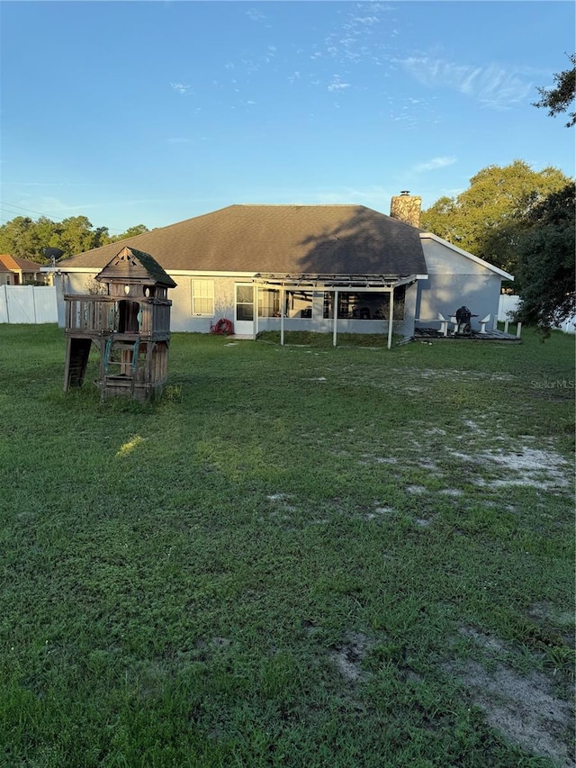 back of house featuring a gazebo and a yard