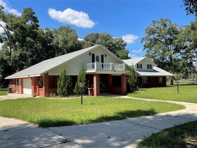 9526 SW 72nd Ct, Ocala, FL 34476 - view of front facade with a front yard, a garage, brick siding, concrete driveway, and a balcony
