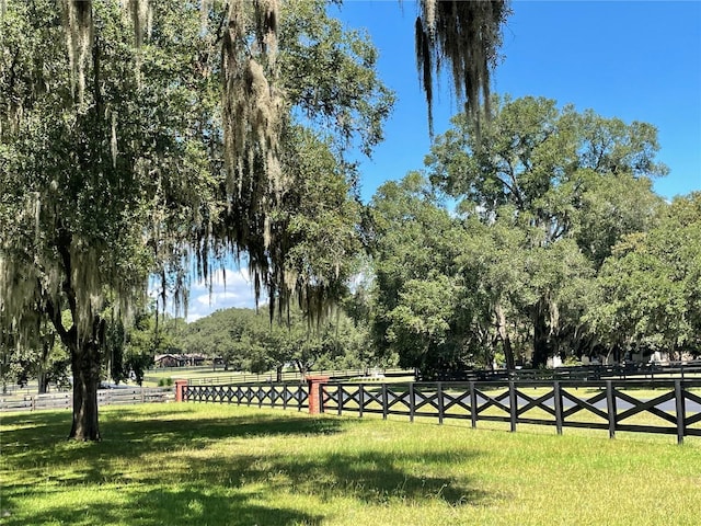 view of home's community with a yard and a rural view