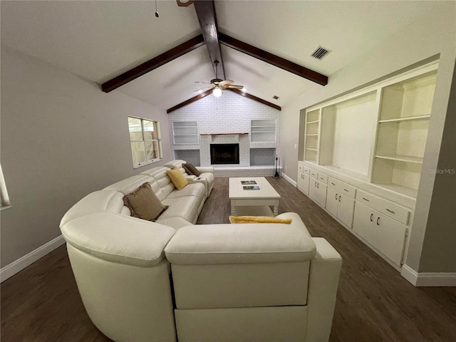 living room featuring vaulted ceiling with beams, dark hardwood / wood-style floors, a brick fireplace, and ceiling fan