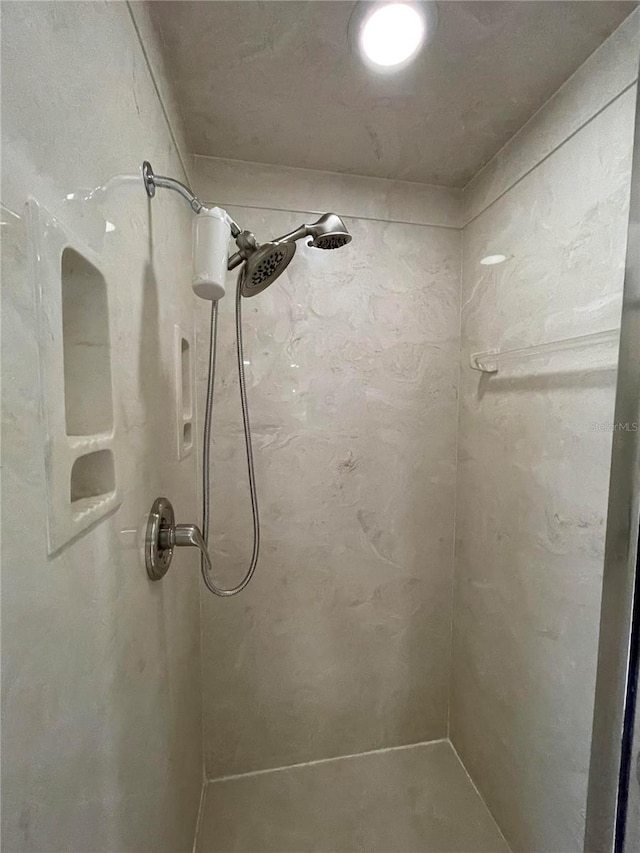 bathroom with a tile shower