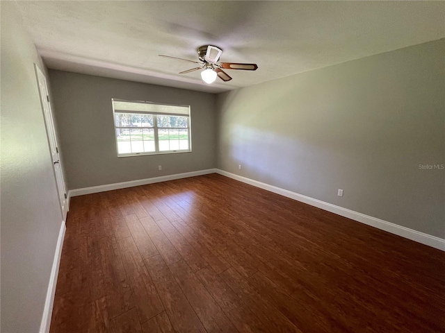 spare room featuring ceiling fan and dark hardwood / wood-style flooring