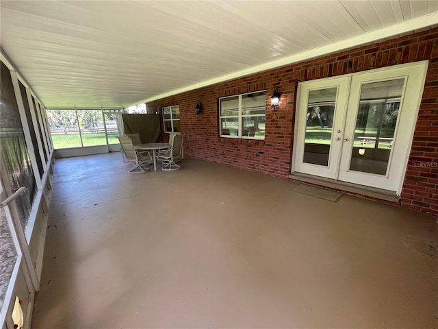 unfurnished sunroom with french doors