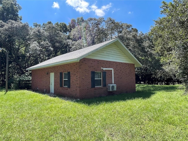 view of property exterior with a wall unit AC and a lawn