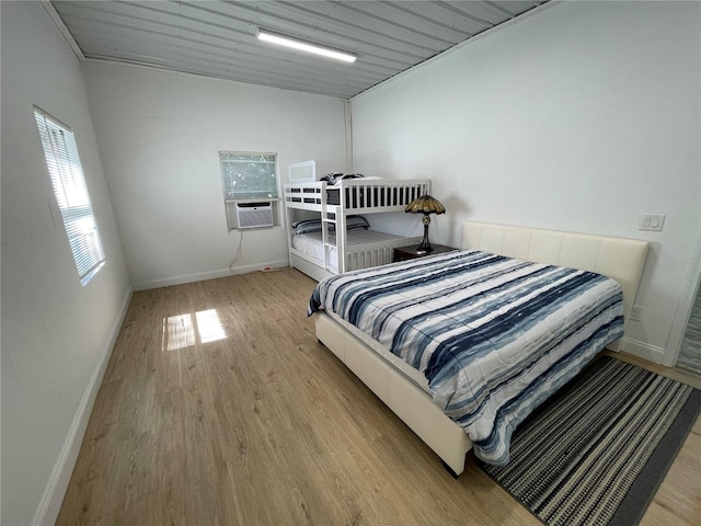 bedroom featuring light hardwood / wood-style floors and cooling unit