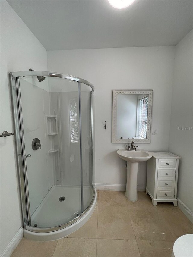 9526 SW 72nd Ct, Ocala, FL 34476 - full bathroom featuring a stall shower, baseboards, tile patterned floors, and a sink