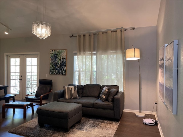 living room featuring french doors, a chandelier, and hardwood / wood-style floors