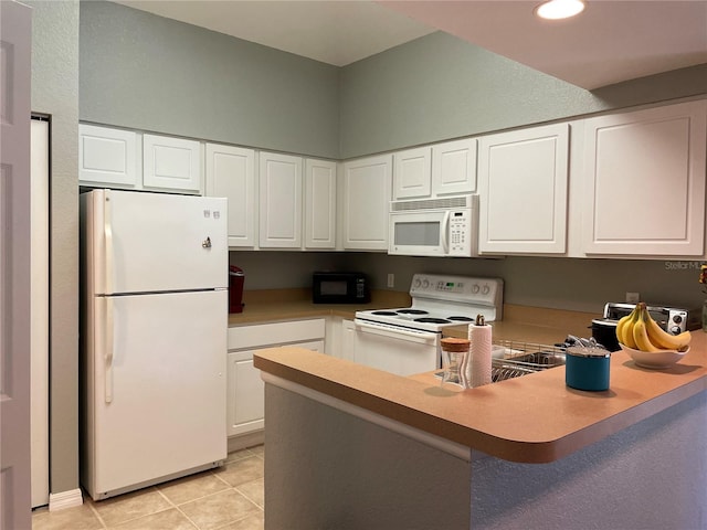 kitchen featuring white appliances, light tile patterned flooring, kitchen peninsula, and white cabinets