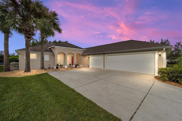 view of front of property with a lawn and a garage