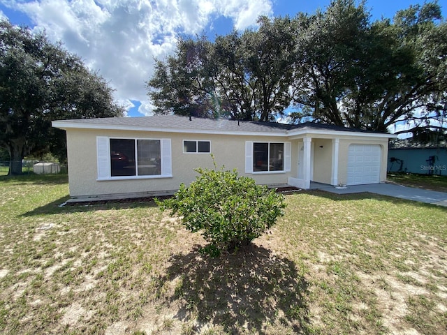 ranch-style house featuring a front yard and a garage