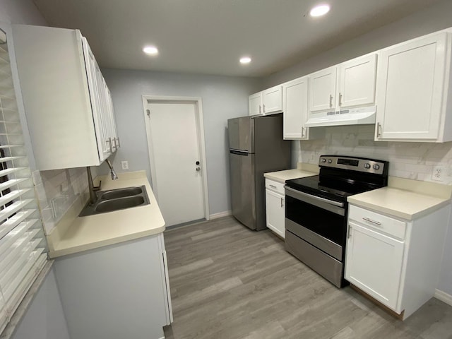 kitchen with decorative backsplash, light hardwood / wood-style floors, white cabinets, stainless steel appliances, and sink