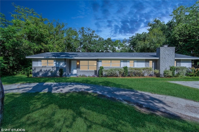 ranch-style home with a front lawn