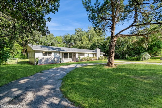 ranch-style home featuring a front yard