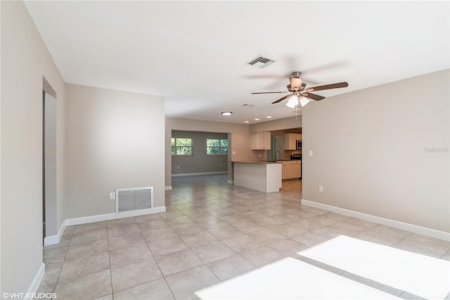 interior space with ceiling fan, light tile patterned flooring, and sink