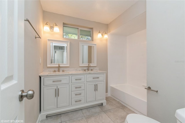 full bathroom with vanity, toilet, washtub / shower combination, and tile patterned floors