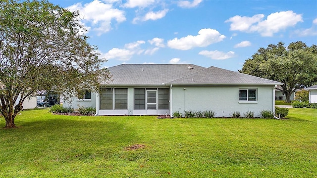 rear view of house featuring a lawn