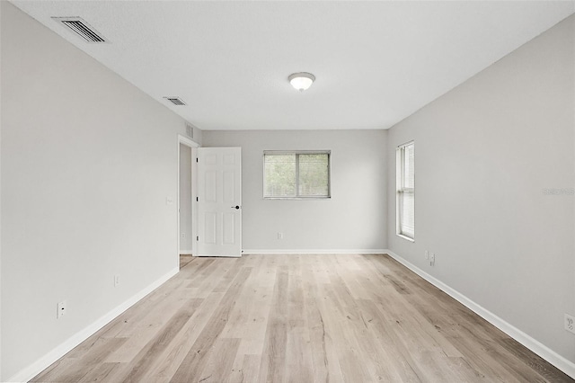 spare room with light hardwood / wood-style flooring