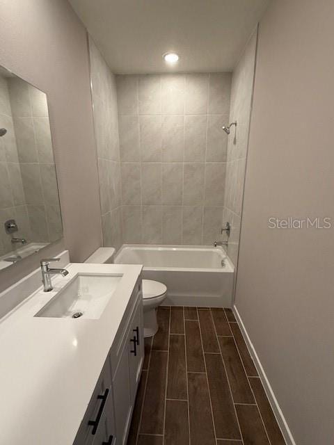 full bathroom featuring vanity, toilet, and tiled shower / bath combo