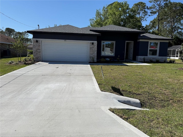 prairie-style house with a front lawn, driveway, and an attached garage